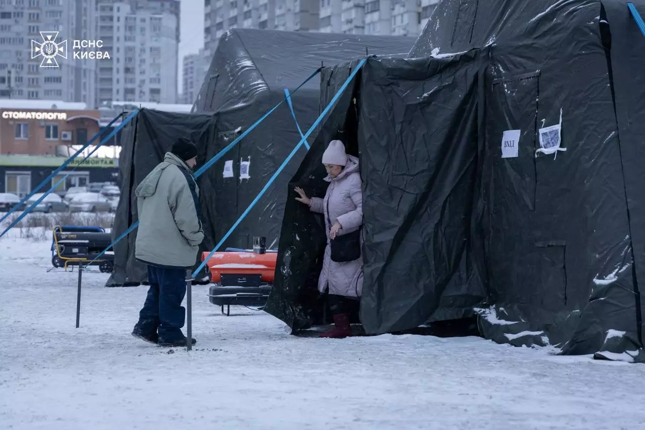 Люди біля тимчасових наметів ДСНС у Києві після російської атаки на інфраструктуру