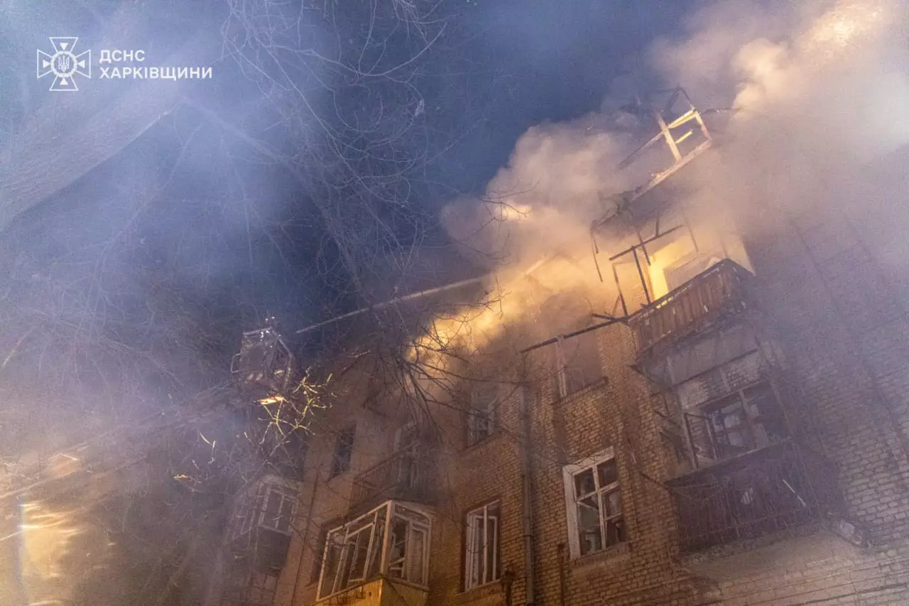 Палаючий житловий будинок після нічного обстрілу в Харкові, дим піднімається в нічне небо