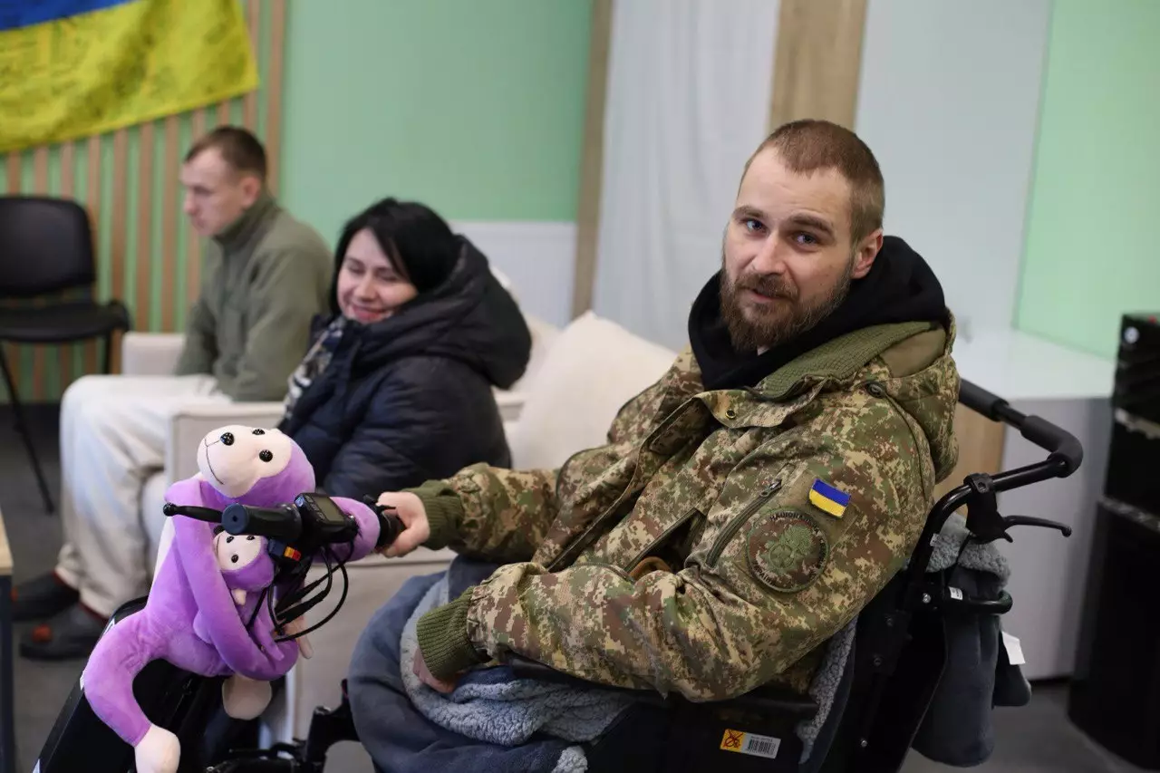 Ветеран у військовій формі на інвалідному візку отримує консультацію в сервісному центрі МВС